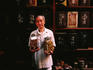 Herbalist displaying dried medicines in Chinatown shop.
