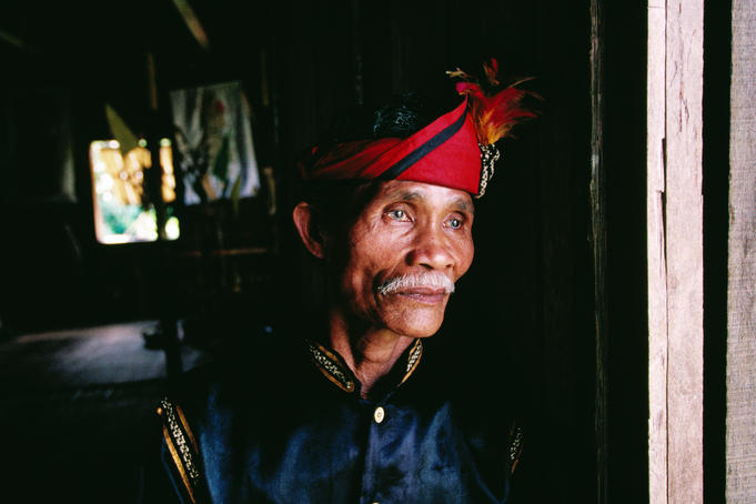 Man in traditional costume at cultural centre on outskirts of Kuching.