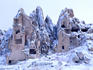 Snow-capped rock caves and pigeon houses near Goreme.