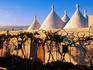 Trulli rooftops and vines.