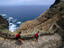 People hiking on coast.