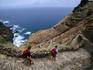 People hiking on coast.