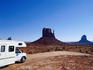 RV (campervan) in front of mittens and mesas.