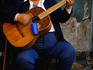 Portrait of blind beggar with guitar.