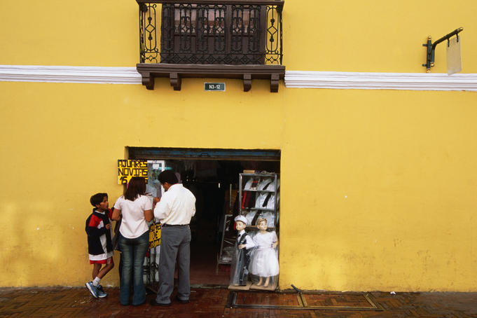 People shopping at a small store in the Old Quarter.