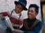 Boy and father reading book.