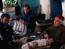 Three men working in saddle shop.