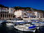 Boats on Hvar Harbour before 16th Century loggia and medieval buildings.