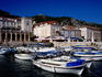 Boats on Hvar Harbour before 16th Century loggia and medieval buildings.