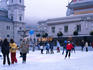 Ice skating in city square.