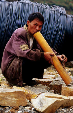 Man smoking from bamboo bong.