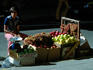 A fruit vendor offering grapes, apples and pears on the streets of San Jose