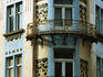 Corner balconies on building facade.