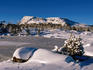 Frozen tarn and King Davids peak under winter snow.