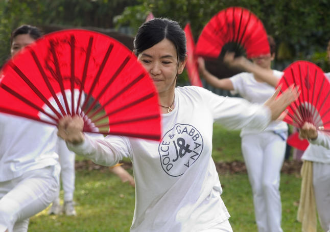 Women dancing with fans.