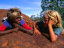Children talking on a rock in the Western Desert.