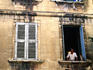 Man with cat in window.