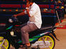 Man on motorbike using mobile phone.