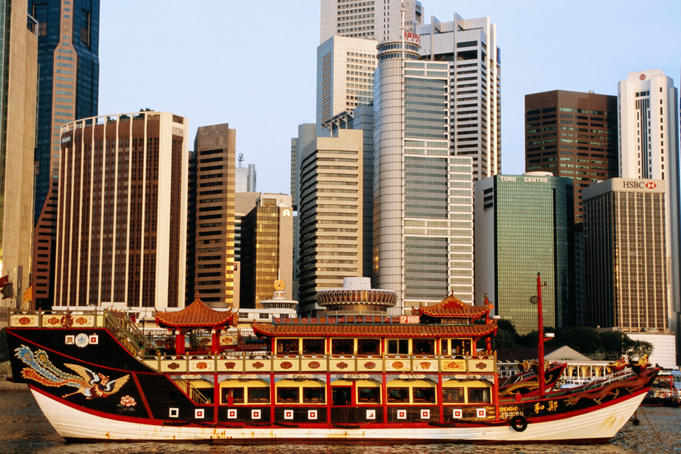 Chinese junk and city skyline at dawn.