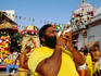Man blowing a conch at Hindu Deepavali Festival, Sri Mariamman Temple.