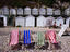 Striped deckchairs and bathing huts on pebbled Beer beach.