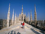 Tourists viewing spires on roof of Duomo.
