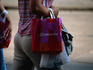 Woman leaving department store La Rinscente with shopping bag.