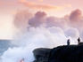 People watching lava flow into ocean.