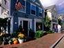 People on main street, past shops.