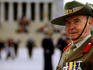 A returned serviceman in uniform showing off his medals outside the Shrine of Remembrance.