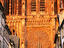 Great rose window of Notre Dame Cathedral's West Front glowing orange in setting sun, Old City.