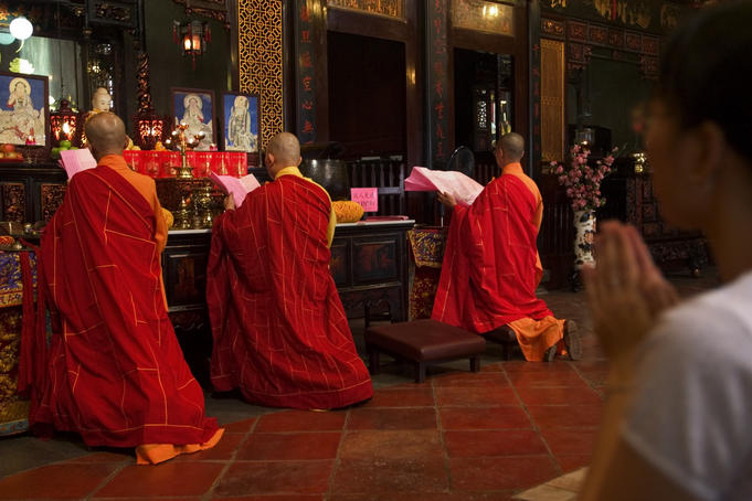Monks and worshippers in Cheng Hong Teng Buddhist Temple, Chinatown.