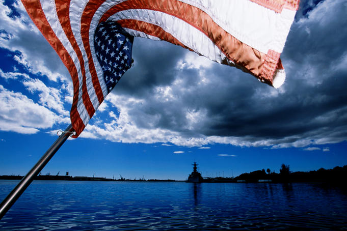 American flag and USS Missouri battleship at USS Arizona Memorial, Pearl Harbour.