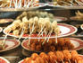 Different types of kebab at a night market.
