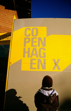 Boy looking at Copenhagen X sign.
