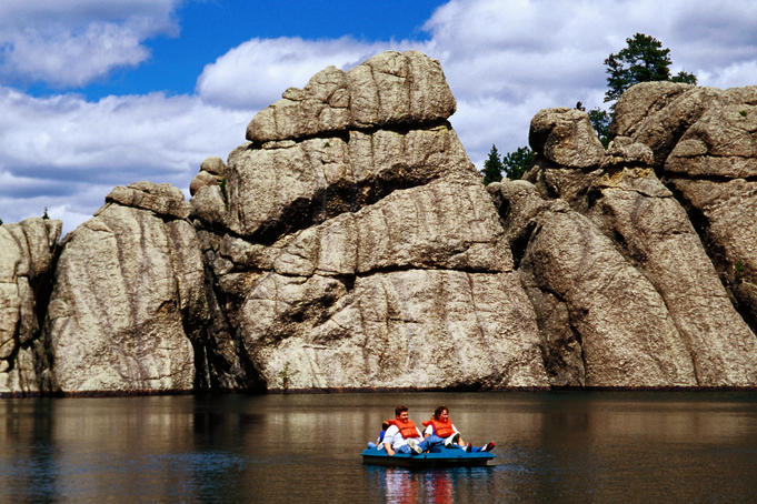 People paddle-boating on Sylvan Lake, Custer State Park.