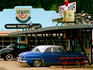 Old vehicles outside Boondocks 50s Cafe and Gas Station, Deadwood.