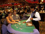 Couple at gaming table with dealer.