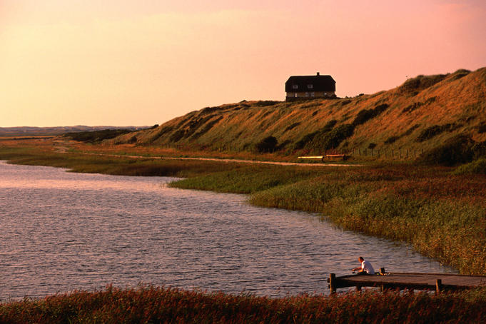 Fishing from pier at Ringkobing Fjord, Nymindegab, Centre Jutland.