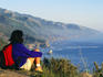 Female hiker looking over scenic coastline.