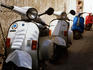 Vespas parked in narrow street.