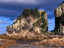 Two sun-bathers standing against a coastal rock formation at Diamond Head, south of Laurieton.