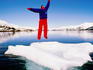 Man in a survival suit jumping on an ice floe, Blackstone Bay.