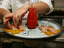 Chef preparing sushi tray at Tojo's Sushi, Fairview.