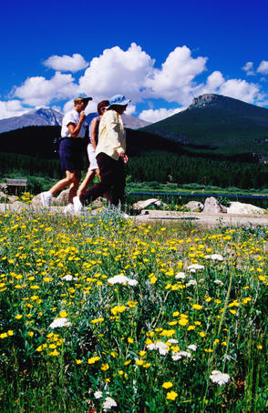 Low angle view of people walking past Lily Lake.