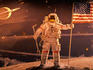 Astronaut holding American flag in space mural by Robert McCall, National Air and Space Museum.