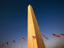 American flags flying at base of Washington Monument.