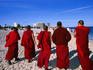 Tibetan monks in red robes walking along South Beach.