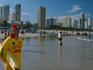 Lifesavers standing on a beach with people in the background.