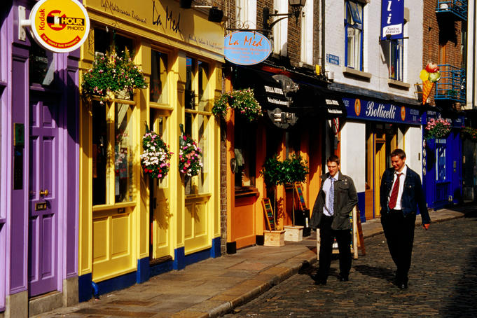 Two men walk past shops in Temple Bar area.